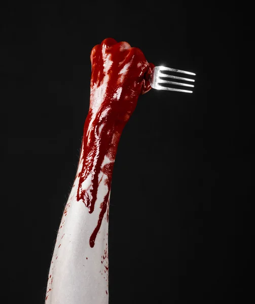 Bloody hand holding a spoon, fork, halloween theme, bloody spoon, fork, black background, isolated — Stock Photo, Image