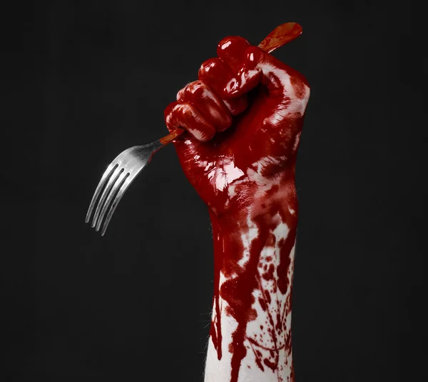 Bloody hand holding a spoon, fork, halloween theme, bloody spoon, fork, black background, isolated — Stock Photo, Image