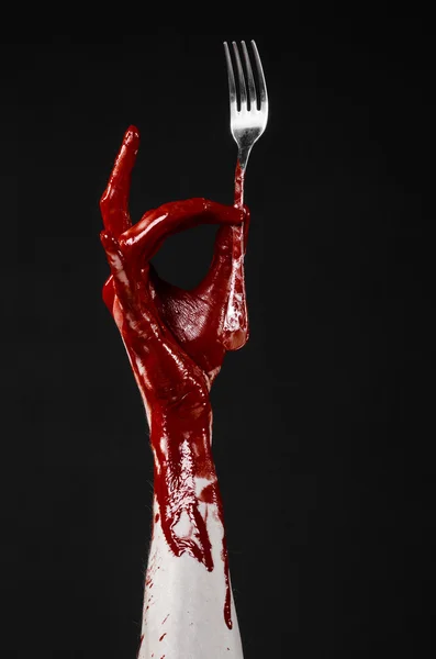 Bloody hand holding a spoon, fork, halloween theme, bloody spoon, fork, black background, isolated — Stock Photo, Image