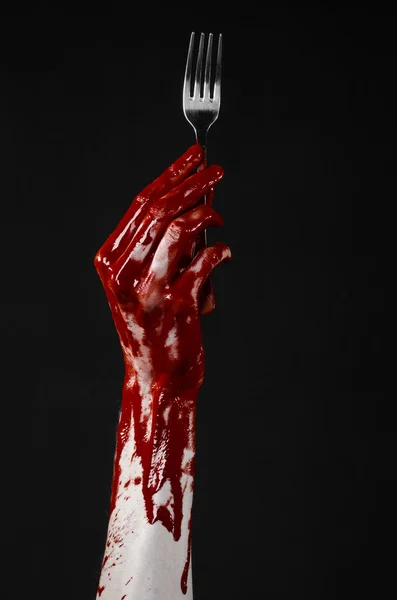 Bloody hand holding a spoon, fork, halloween theme, bloody spoon, fork, black background, isolated — Stock Photo, Image