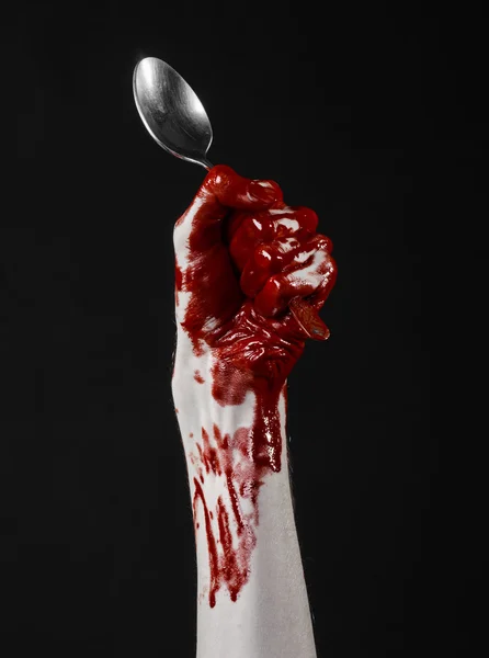 Bloody hand holding a spoon, fork, halloween theme, bloody spoon, fork, black background, isolated — Stock Photo, Image