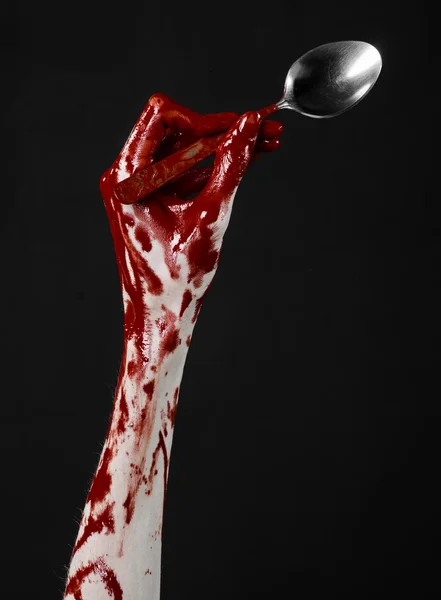 Bloody hand holding a spoon, fork, halloween theme, bloody spoon, fork, black background, isolated — Stock Photo, Image