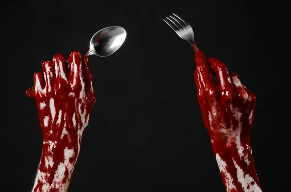 Bloody hand holding a spoon, fork, halloween theme, bloody spoon, fork, black background, isolated — Stock Photo, Image