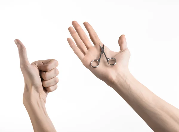 Health and personal care: Hand holding scissors for manicure isolated on white background — Stock Photo, Image