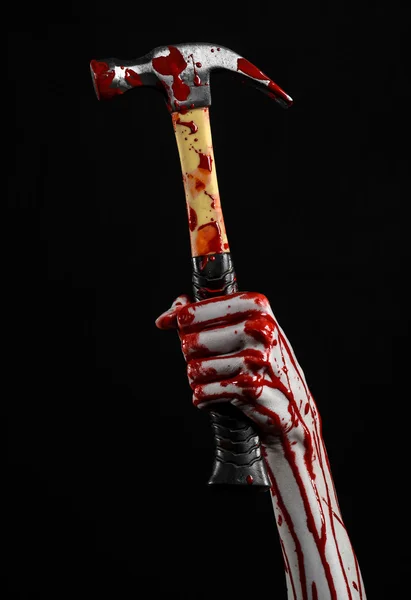 Krwawe halloween tematu: krwawa ręka trzyma krwawe młoteczek na białym tle na czarnym tle — Zdjęcie stockowe