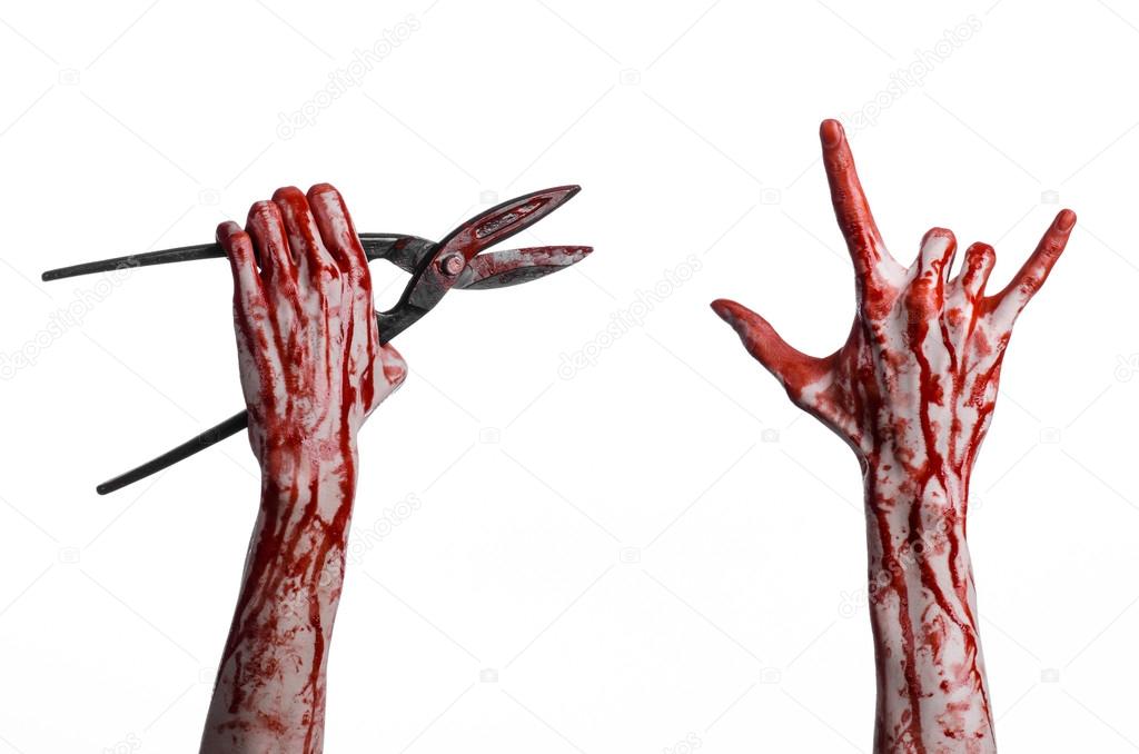 Halloween theme: bloody hand holding a big old bloody scissors on a white background