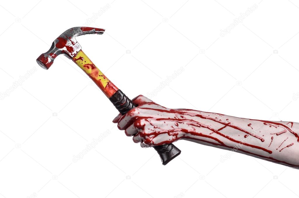 Bloody halloween theme: bloody hand holding a bloody hammer isolated on a white background