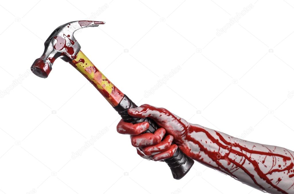 Bloody halloween theme: bloody hand holding a bloody hammer isolated on a white background