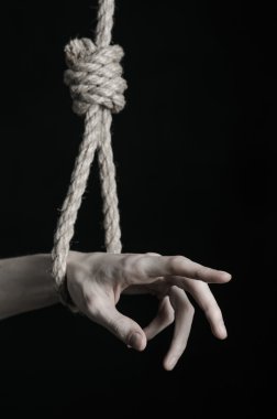 Depresyon ve intihar Konu: insan eli ip döngü siyah bir arka plan asılı