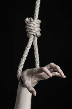 Depresyon ve intihar Konu: insan eli ip döngü siyah bir arka plan asılı