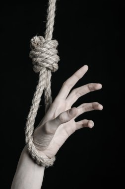 Depresyon ve intihar Konu: insan eli ip döngü siyah bir arka plan asılı