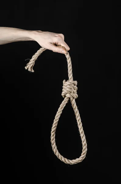 Lynchmord und Selbstmord Thema: Mann die Hand hält eine Schlaufe Seil zum Aufhängen auf schwarzem Hintergrund isoliert — Stockfoto