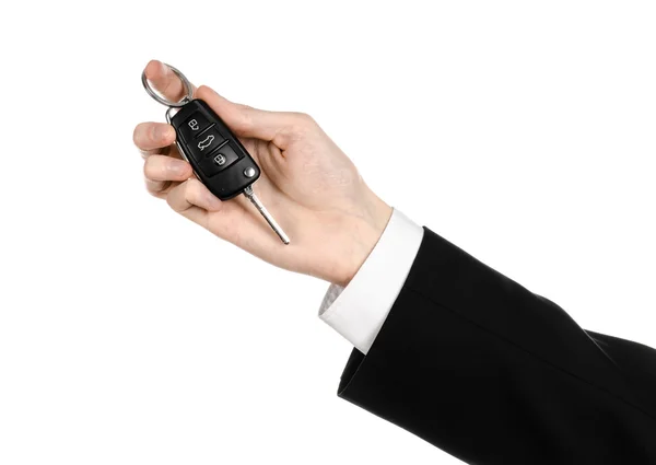 Zakelijke thema: autoverkoper in een zwart pak een auto knop ingedrukt geïsoleerd op witte achtergrond — Stockfoto
