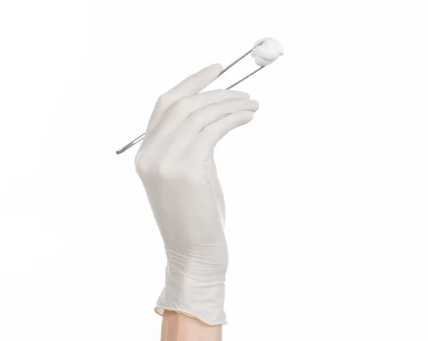 Medicine and Surgery theme: doctor's hand in a white glove holding tweezers with swab isolated on white background in studio — Stock Photo, Image