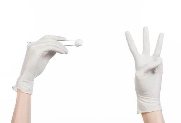 Medicine and Surgery theme: doctor's hand in a white glove holding tweezers with swab isolated on white background in studio — Stock Photo, Image