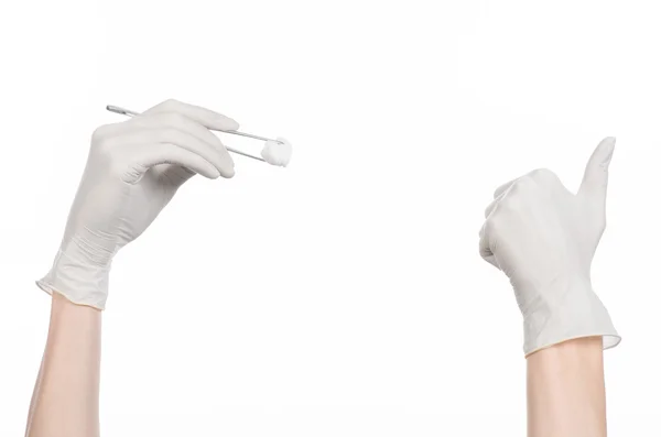 Medicine and Surgery theme: doctor's hand in a white glove holding tweezers with swab isolated on white background in studio — Stock Photo, Image