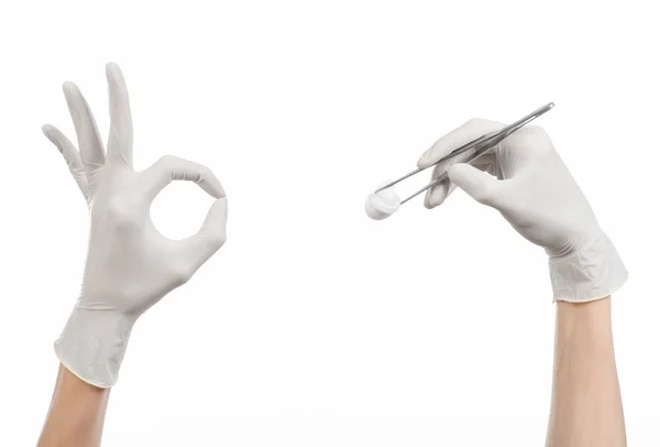 Medicine and Surgery theme: doctor's hand in a white glove holding tweezers with swab isolated on white background in studio — Stock Photo, Image