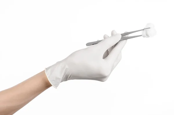 Medicine and Surgery theme: doctor's hand in a white glove holding tweezers with swab isolated on white background in studio — Stock Photo, Image