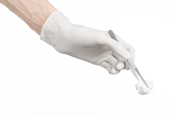 Medicine and Surgery theme: doctor's hand in a white glove holding tweezers with swab isolated on white background in studio — Stock Photo, Image