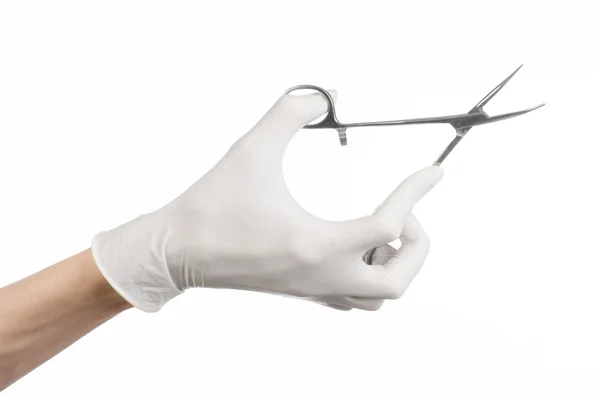 Chirurgie und medizinisches Thema: Die Hand des Arztes in einem weißen Handschuh mit einem Chirurgenclip auf weißem Hintergrund — Stockfoto