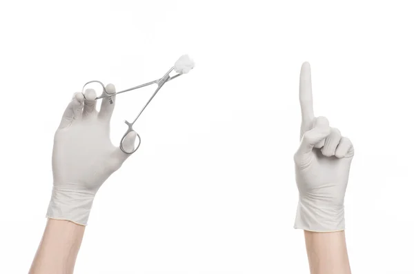 Surgery and medicine theme: doctor's hand in a white glove holding a surgical clamp with swab isolated on white background in studio — Stock Photo, Image