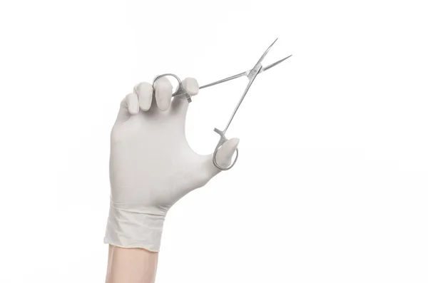 Kirurgi og medisinsk tema: legens hånd i en hvit hanske som holder et kirurgisk klipp isolert på hvit bakgrunn – stockfoto