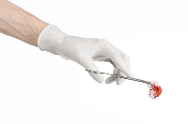 Surgery and Medical theme: doctor's hand in a white glove holding a surgical clip with a bloody tampon isolated on a white background in studio — Stock Photo, Image