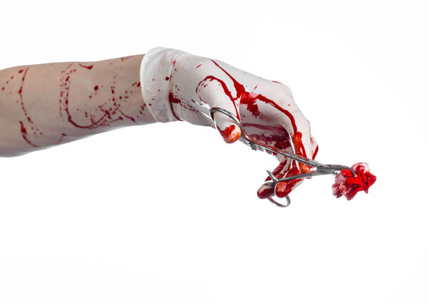 Surgery and medicine theme: doctor bloody hand in glove holding a bloody surgical clamp with swab and performs surgery on an isolated white background in studio