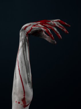 Bloody Halloween theme: horrible zombie demon bloody hands on a black background clipart