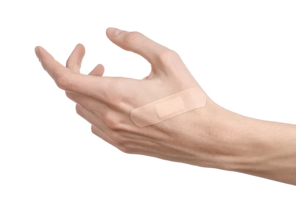 Medical theme: for a man's hand glued medical plaster first aid plaster advertising on a white background — Stock Photo, Image