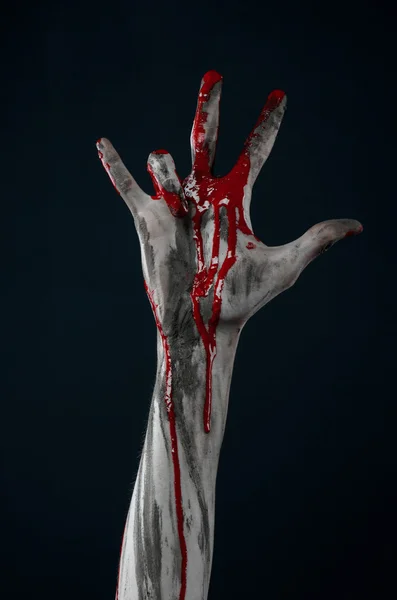 Bloody Halloween theme: horrible zombie demon bloody hands on a black background