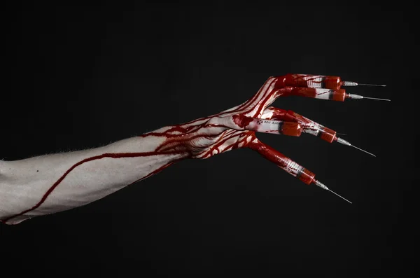 Bloody hand with syringe on the fingers, toes syringes, hand syringes, horrible bloody hand, halloween theme, zombie doctor, black background, isolated — Stock Photo, Image