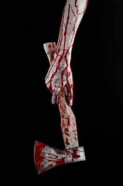 Bloody Halloween theme: bloody hand holding a bloody butcher's ax isolated on black background in studio — Stock Photo, Image