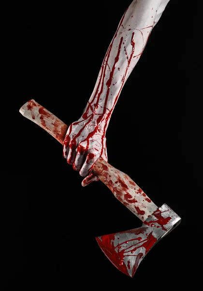 Bloody Halloween theme: bloody hand holding a bloody butcher's ax isolated on black background in studio — Stock Photo, Image