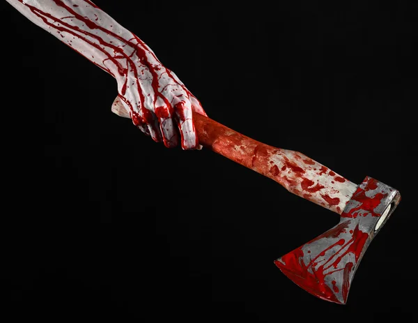 Bloody Halloween theme: bloody hand holding a bloody butcher's ax isolated on black background in studio — Stock Photo, Image