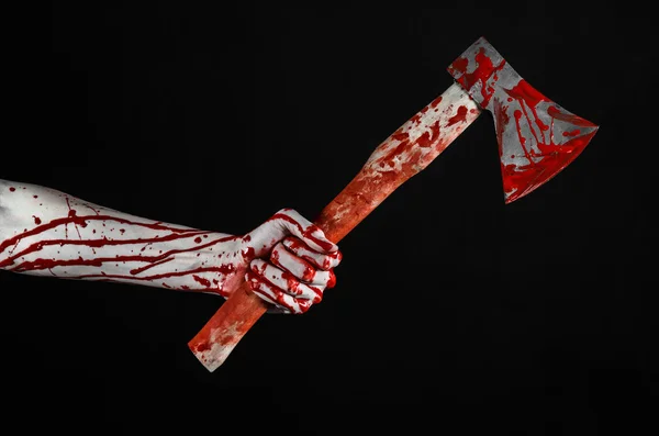 Bloody Halloween theme: bloody hand holding a bloody butcher's ax isolated on black background in studio — Stock Photo, Image