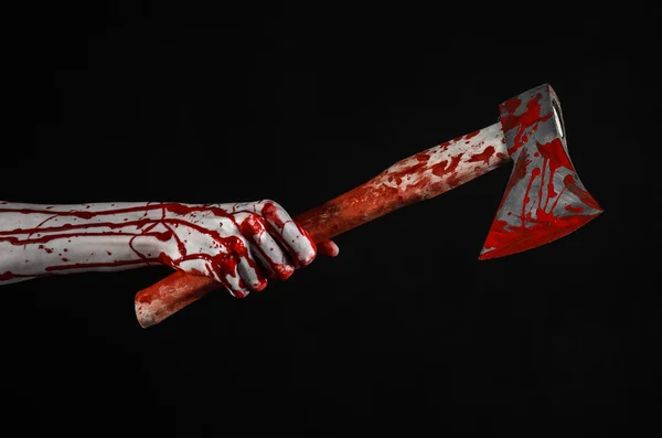 Bloody Halloween theme: bloody hand holding a bloody butcher's ax isolated on black background in studio — Stock Photo, Image