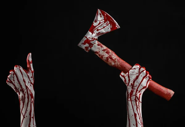 Bloody Halloween theme: bloody hand holding a bloody butcher's ax isolated on black background in studio — Stock Photo, Image