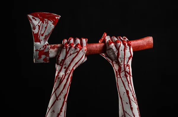 Bloody Halloween theme: bloody hand holding a bloody butcher's ax isolated on black background in studio — Stock Photo, Image