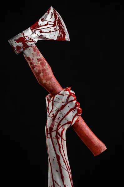 Bloody Halloween theme: bloody hand holding a bloody butcher's ax isolated on black background in studio — Stock Photo, Image