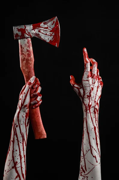 Bloody Halloween theme: bloody hand holding a bloody butcher's ax isolated on black background in studio — Stock Photo, Image