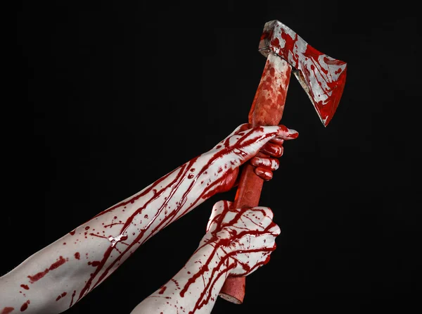 Bloody Halloween theme: bloody hand holding a bloody butcher's ax isolated on black background in studio — Stock Photo, Image