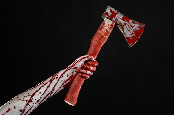 Bloody Halloween theme: bloody hand holding a bloody butcher's ax isolated on black background in studio — Stock Photo, Image