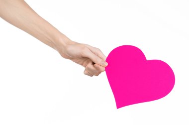 Sevgililer günü ve aşk şarkısı: Studio beyaz bir arka plan üzerinde izole bir pembe kalp tutan el