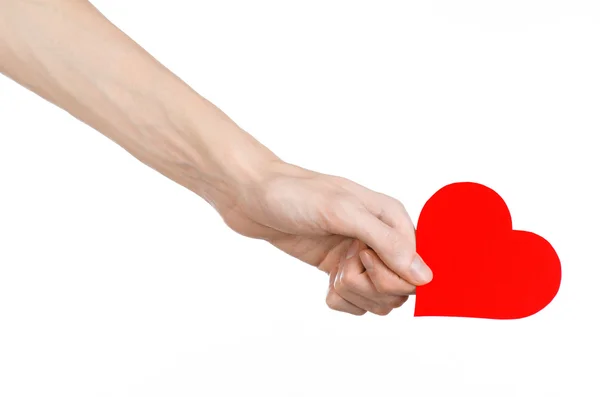 Valentine's Day and love theme: hand holding a red heart isolated on a white background in studio — Stock Photo, Image