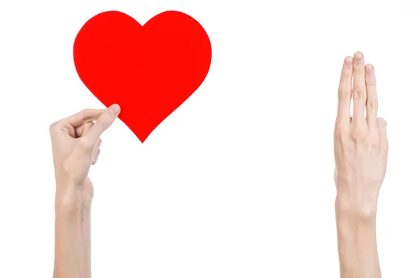 Valentine's Day and love theme: hand holding a red heart isolated on a white background in studio — Stock Photo, Image