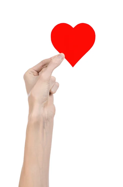 Valentine's Day and love theme: hand holding a red heart isolated on a white background in studio — Stock Photo, Image