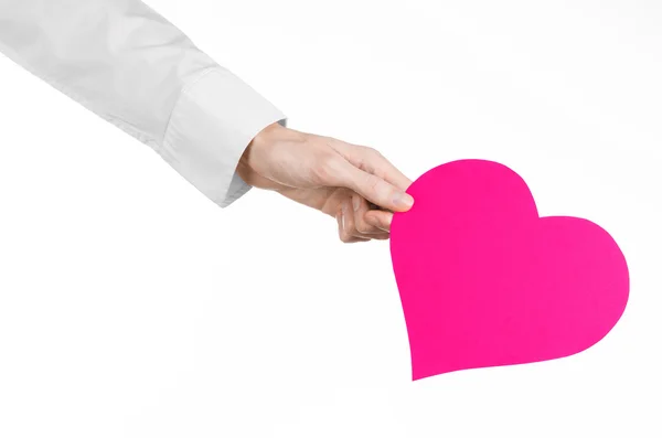 Heart Disease and Health Topic: hand doctor in a white shirt holding a card in the form of a pink heart isolated on a white background in studio — Stock Photo, Image