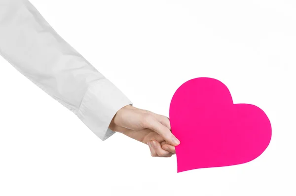 Heart Disease and Health Topic: hand doctor in a white shirt holding a card in the form of a pink heart isolated on a white background in studio — Stock Photo, Image