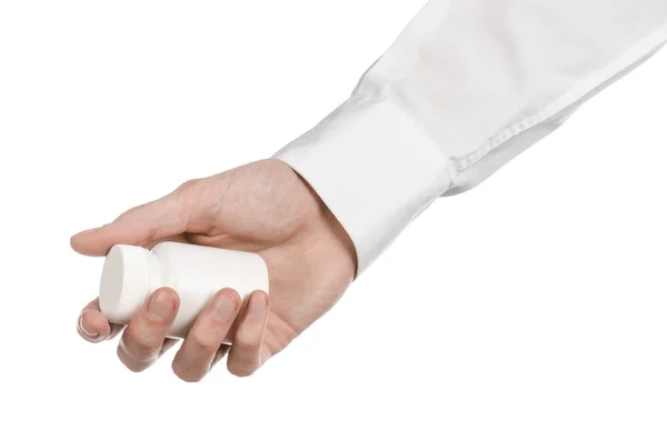 Medical theme: doctor's hand holding a white empty jar of pills on a white background — Stock Photo, Image